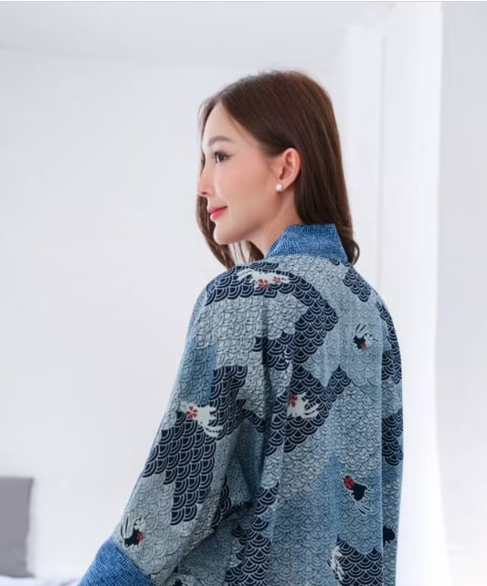 Embroidered plaid robe with tortoise-shell trim; arms positioned above the shoulders; arms falling along each shoulder.